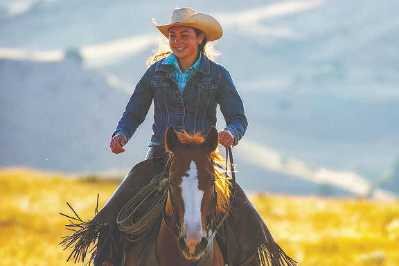A cowgirl riding a horse