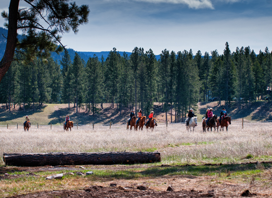 Trail riding at Paws Up Montana Cowgirl Roundup